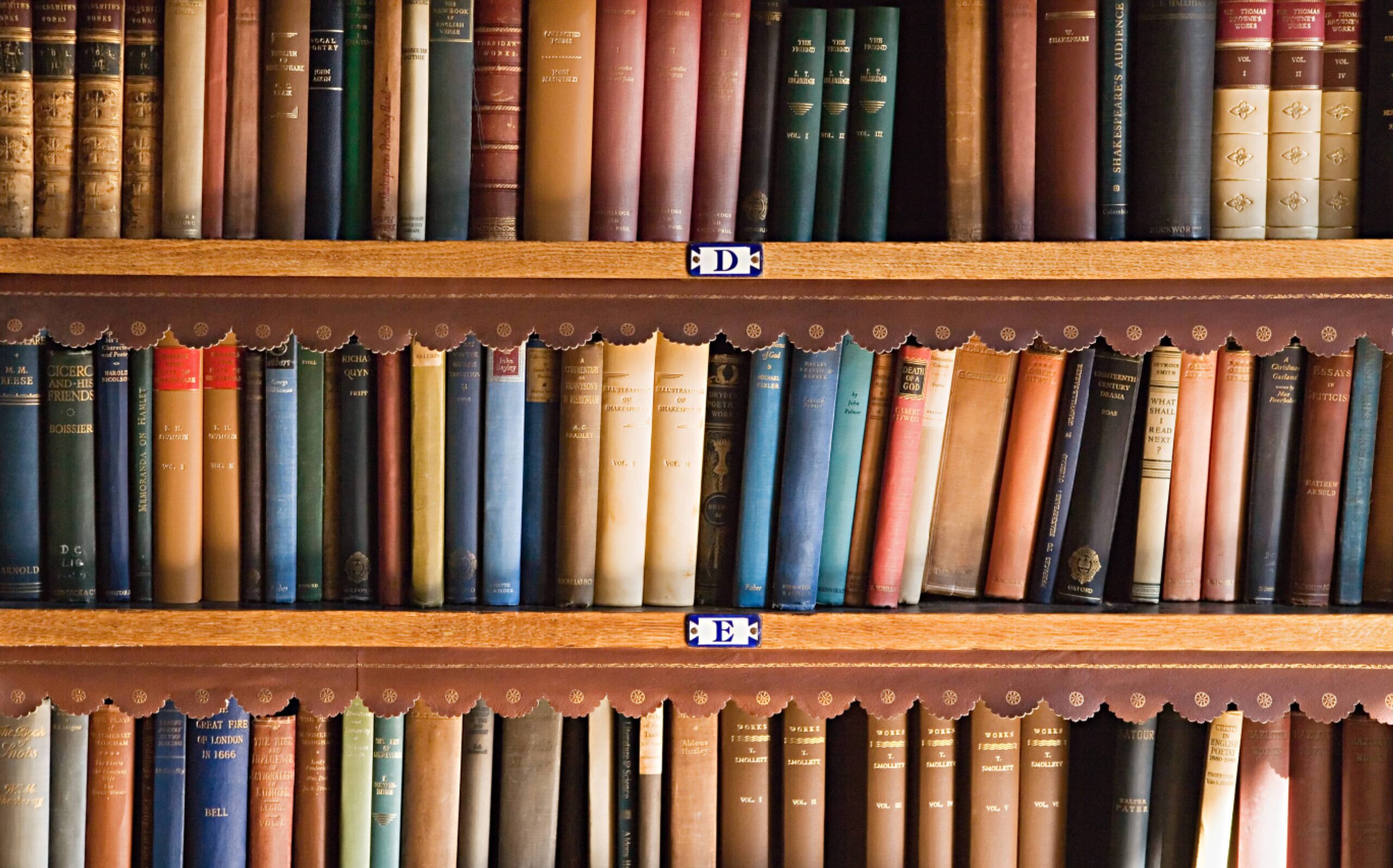 Colorful books on wooden bookshelf
